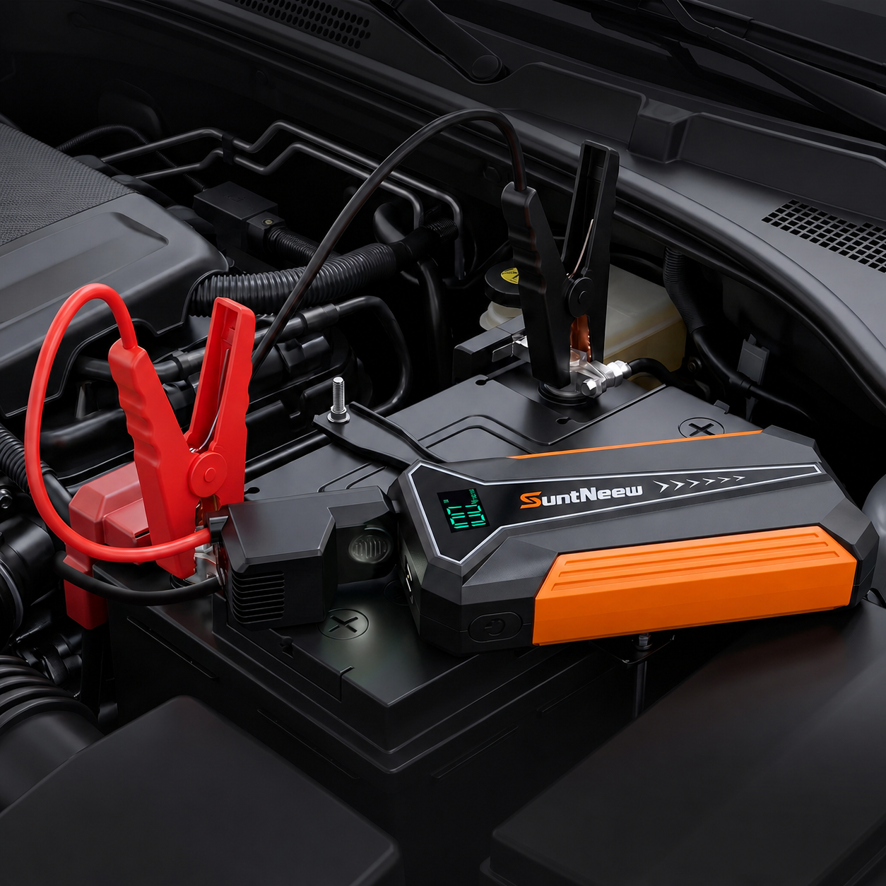 SuntNeew A20 orange jump starter connected in an engine bay