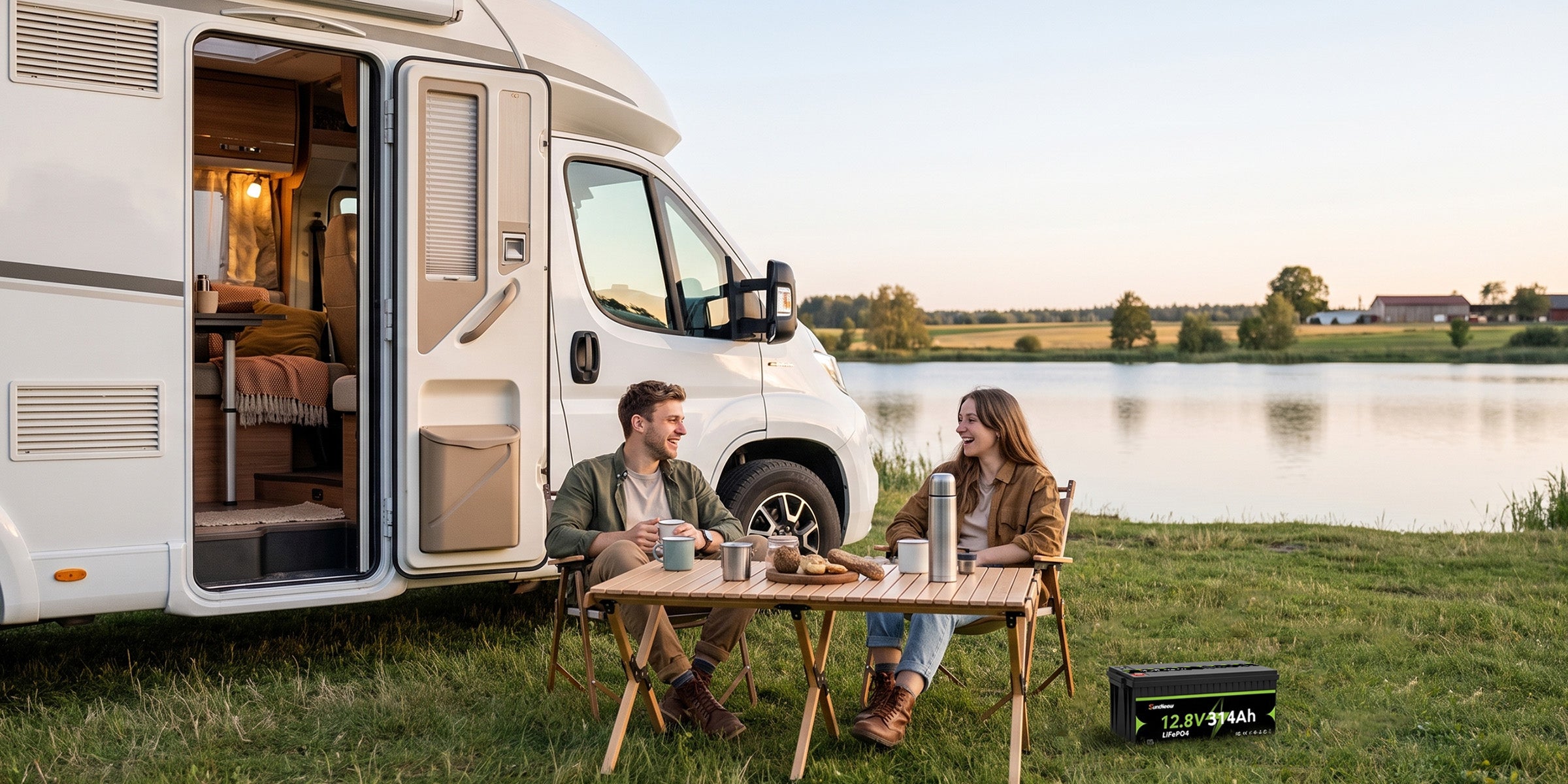 SuntNeew 314Ah LiFePO4 battery beside a motorhome at a lakeside campsite